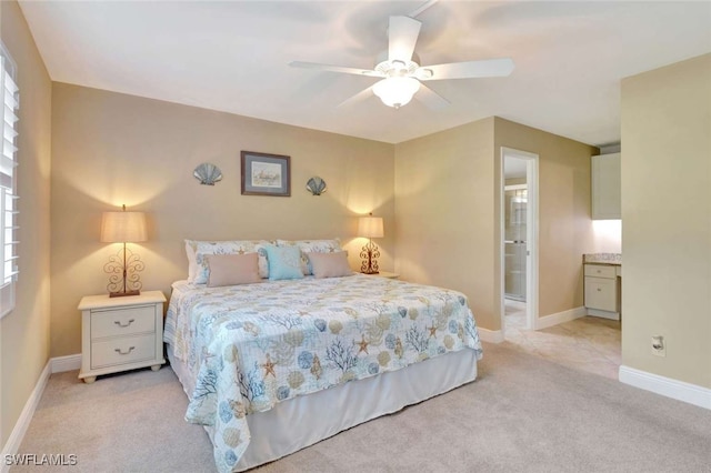 carpeted bedroom with ceiling fan and connected bathroom