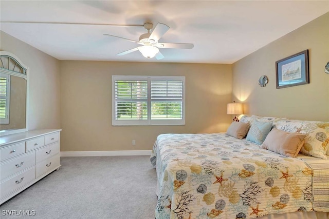 bedroom with ceiling fan and light colored carpet