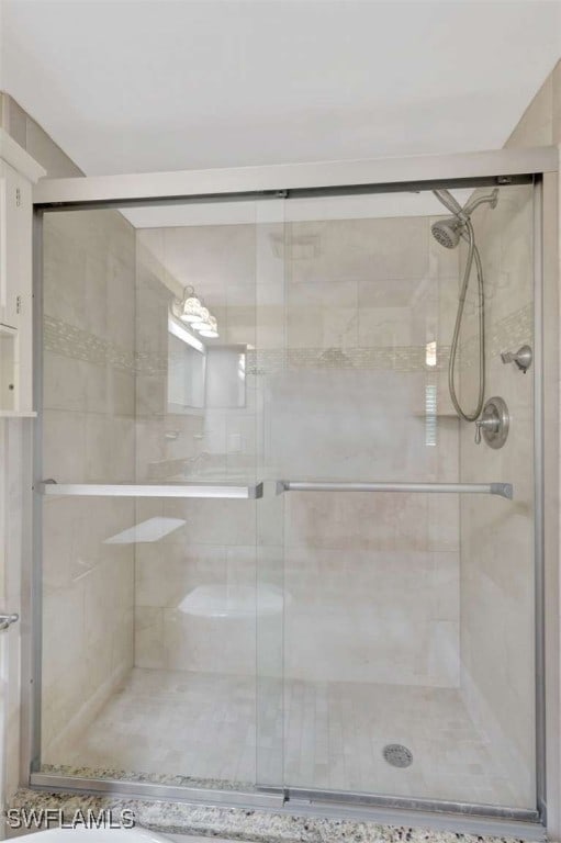 bathroom with a shower with shower door