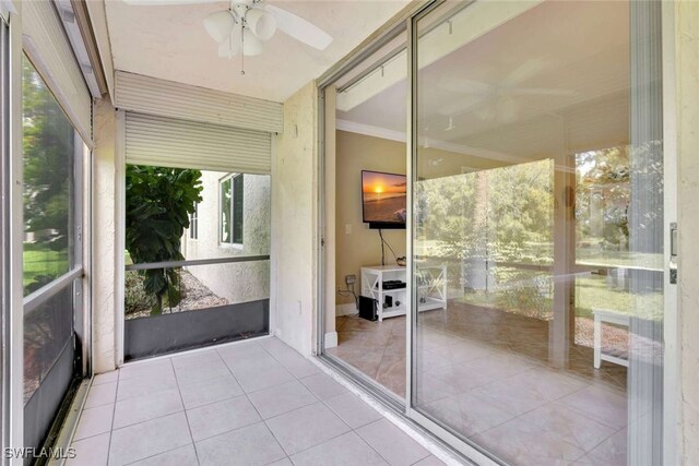 unfurnished sunroom with ceiling fan