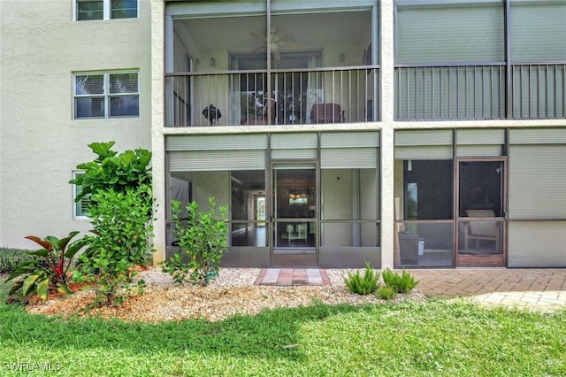 rear view of property with a sunroom