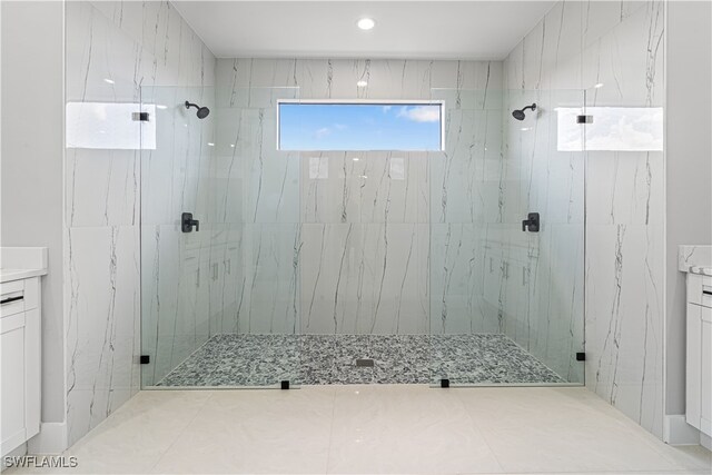 bathroom with vanity and a shower with shower door