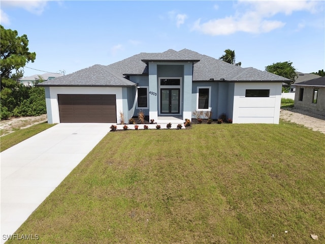 prairie-style house with a front lawn and a garage