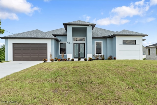 prairie-style house with a front lawn and a garage