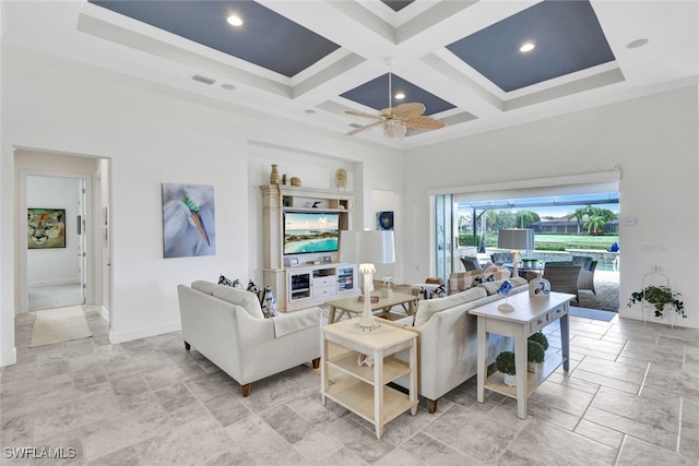 living room with beam ceiling, coffered ceiling, a high ceiling, and ceiling fan