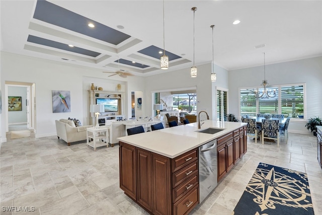 kitchen featuring a towering ceiling, sink, hanging light fixtures, coffered ceiling, and a center island with sink