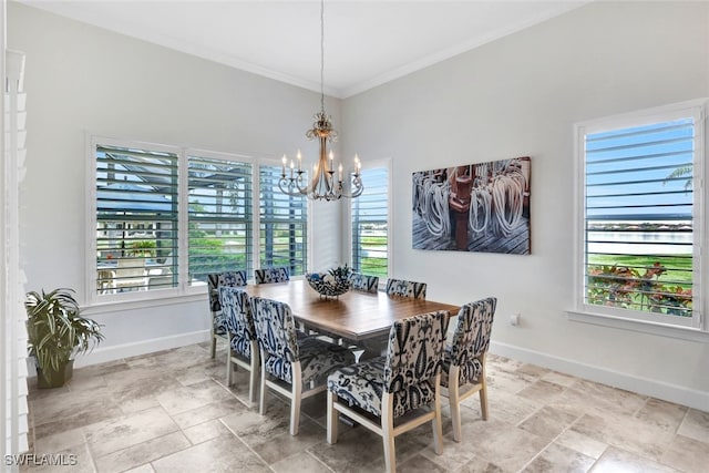 dining room with crown molding and a notable chandelier