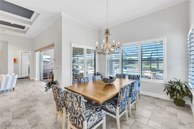 dining area featuring crown molding, an inviting chandelier, plenty of natural light, and a high ceiling