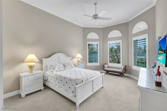 bedroom featuring ornamental molding, light colored carpet, a high ceiling, and ceiling fan