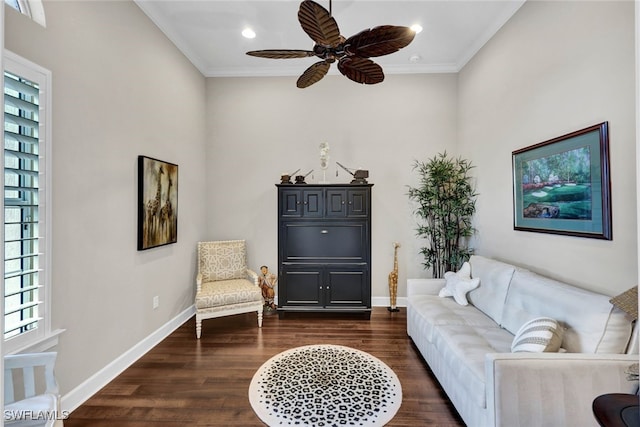 living room with crown molding, dark wood-type flooring, and ceiling fan