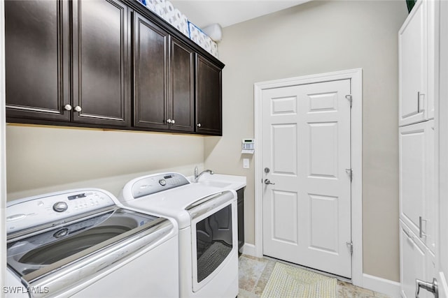 clothes washing area with cabinets, independent washer and dryer, sink, and light tile patterned flooring