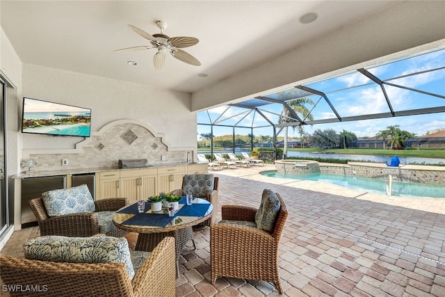 view of patio featuring a pool with hot tub, a lanai, a water view, and ceiling fan