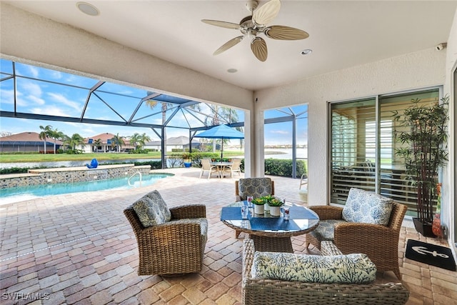 view of patio / terrace with ceiling fan, pool water feature, and glass enclosure