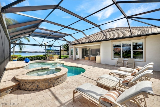 view of swimming pool with a patio, a lanai, an in ground hot tub, and a water view