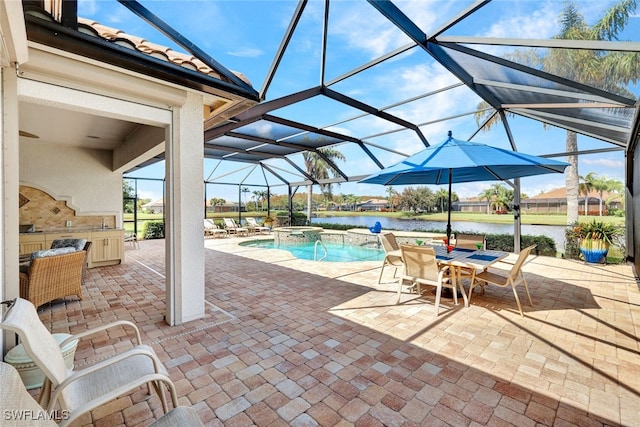 view of pool with a patio, pool water feature, a water view, and a lanai