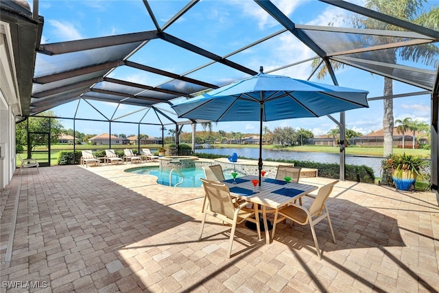 view of pool featuring a patio, a lanai, an in ground hot tub, and a water view