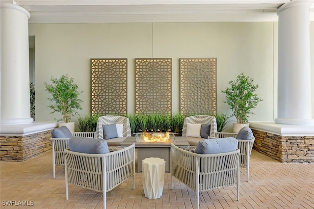 view of patio with an outdoor living space with a fire pit