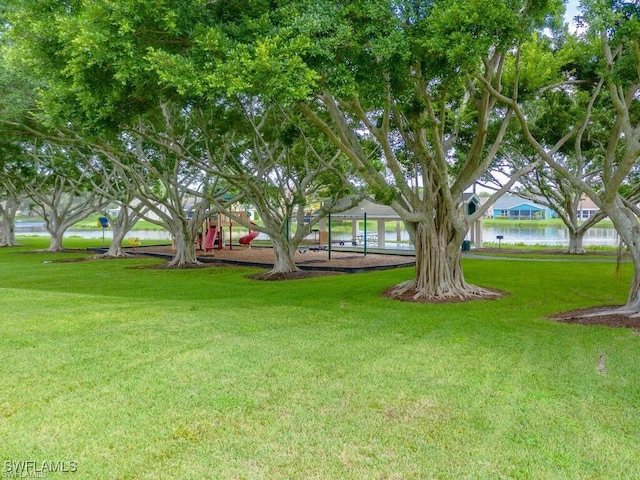 view of yard with a playground and a water view