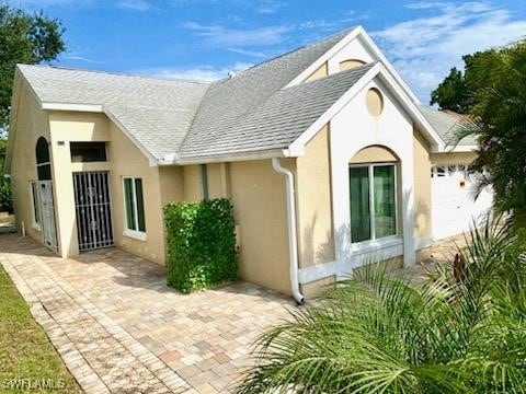 back of house with a garage