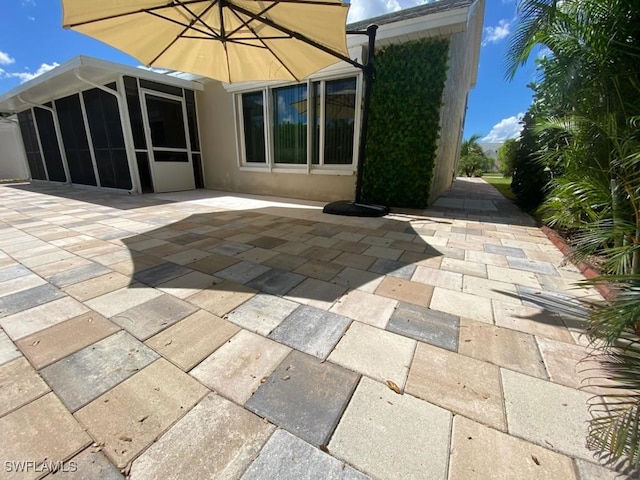 view of patio with a sunroom