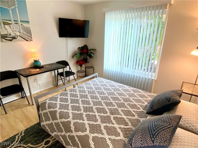 bedroom with hardwood / wood-style flooring