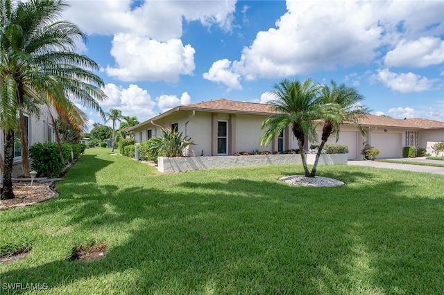 view of front of house with a front lawn and a garage