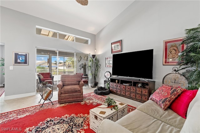 living room with tile patterned flooring and high vaulted ceiling