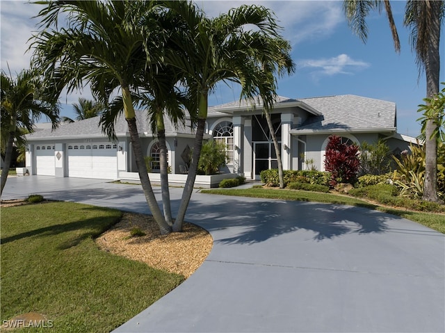 view of front facade with a front yard and a garage