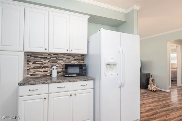 kitchen featuring dark wood-type flooring, crown molding, white fridge with ice dispenser, and white cabinets