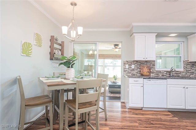 5807 Cubles Dr, Bokeelia, FL 33922 - dining space featuring ornamental molding, ceiling fan with notable chandelier, and wood finished floors