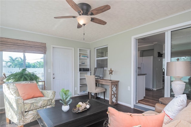 5807 Cubles Dr, Bokeelia, FL 33922 - living area featuring ornamental molding, built in features, wood finished floors, baseboards, and a ceiling fan