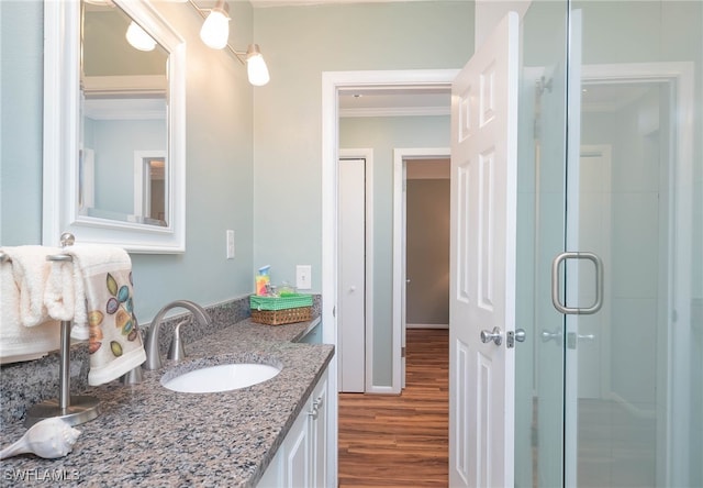 5807 Cubles Dr, Bokeelia, FL 33922 - full bath with vanity, a stall shower, wood finished floors, and ornamental molding