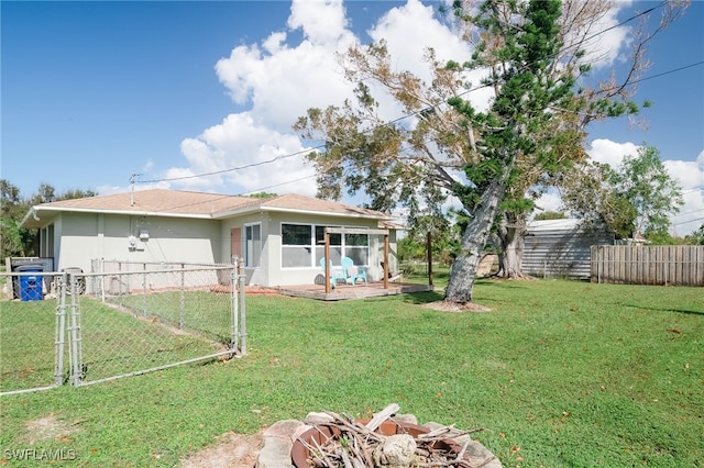 5807 Cubles Dr, Bokeelia, FL 33922 - exterior space featuring stucco siding, a gate, fence, and a front yard