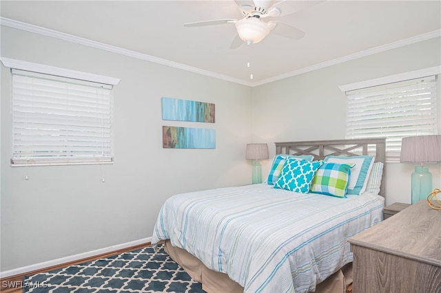 bedroom with crown molding, hardwood / wood-style flooring, and ceiling fan