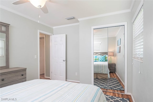 5807 Cubles Dr, Bokeelia, FL 33922 - bedroom featuring visible vents, wood finished floors, baseboards, a closet, and ornamental molding