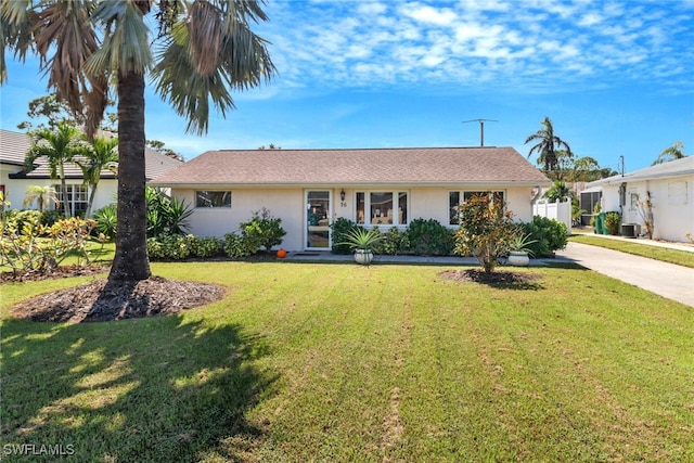 ranch-style house with central AC unit and a front yard