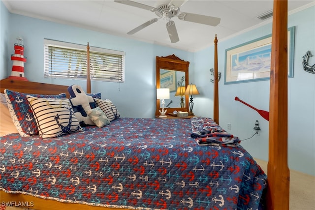 carpeted bedroom featuring ceiling fan and ornamental molding