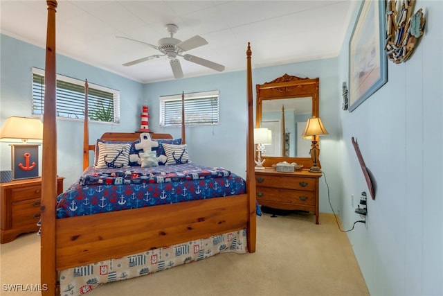 carpeted bedroom with ceiling fan and crown molding