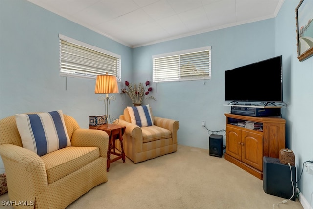 sitting room featuring light colored carpet and crown molding