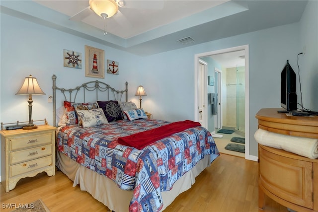 bedroom featuring connected bathroom, ceiling fan, and hardwood / wood-style floors