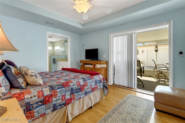 bedroom with ceiling fan, ensuite bathroom, and light hardwood / wood-style floors