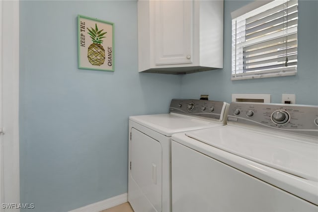 laundry area with washer and clothes dryer and cabinets