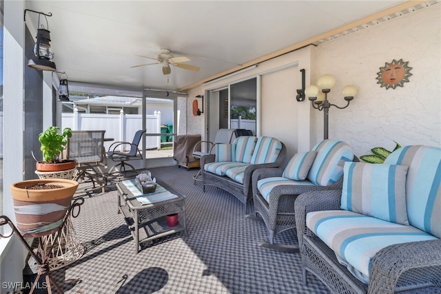 sunroom featuring ceiling fan