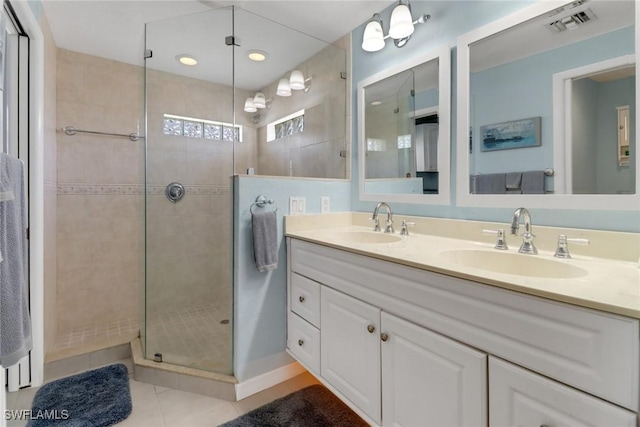 bathroom featuring tile patterned floors, vanity, and an enclosed shower