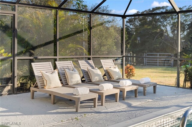 view of patio featuring a lanai