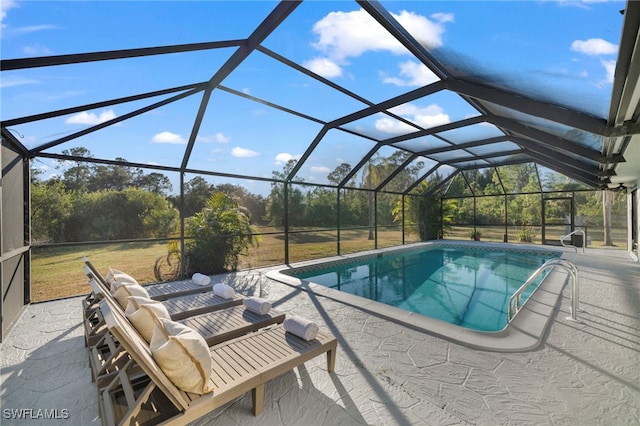 view of pool featuring a patio and glass enclosure