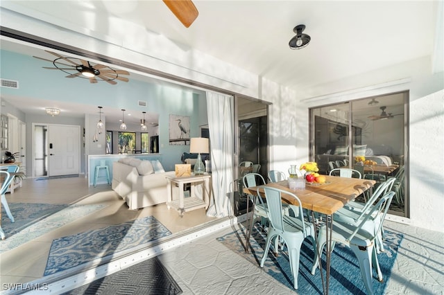 tiled dining area featuring ceiling fan and visible vents