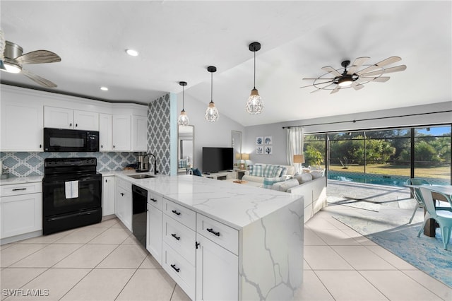 kitchen with white cabinetry, kitchen peninsula, decorative backsplash, vaulted ceiling, and black appliances