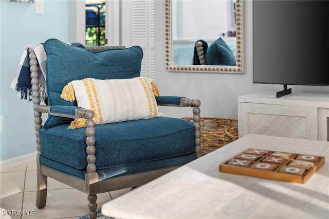 living area featuring baseboards and tile patterned floors
