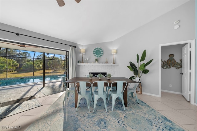 dining space with a ceiling fan, baseboards, and tile patterned flooring